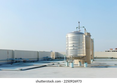 A large stainless steel water tank is mounted top the building  To reserve water when the water supply does not flow