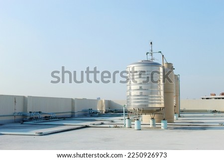 A large stainless steel water tank is mounted on top of the building. To reserve water when the water supply does not flow