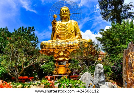 A large statue of golden Buddha. Dalat Vietnam