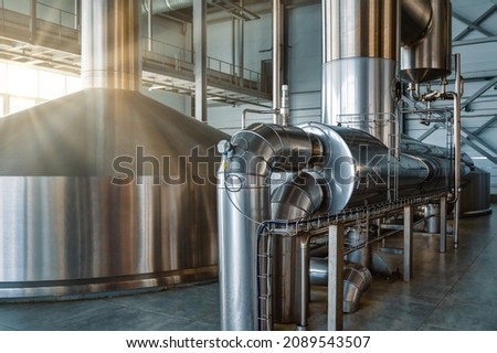 Large steel tanks for yeast fermentation. Industrial production of beer and alcohol