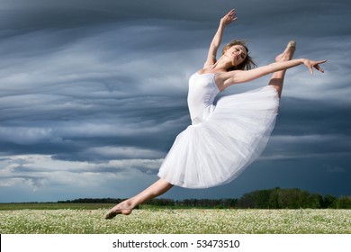 large step of beautiful ballet dancer against cloudy sky - Powered by Shutterstock