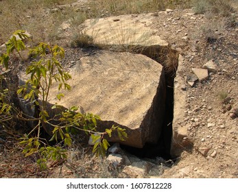 A large stone with a flat surface broke away from the main body of the rock.
