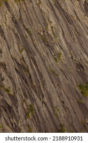 Large Stone Wall Texture With Wet Parts During Sunset.