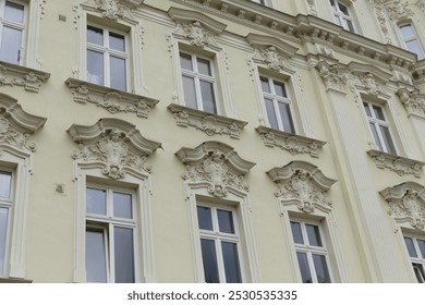 A large structure that features many windows adorning its exterior and providing light to the interiors within it