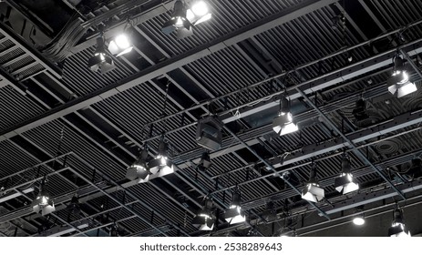 A large studio ceiling rig with exposed structure and many hanging spotlights