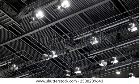 A large studio ceiling rig with exposed structure and many hanging spotlights