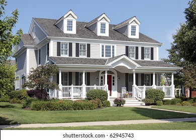 Large Suburban Home With Front Porch And Arched Entry