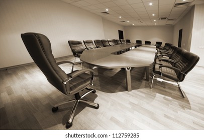 A Large Table And Chairs In A Modern Conference Room