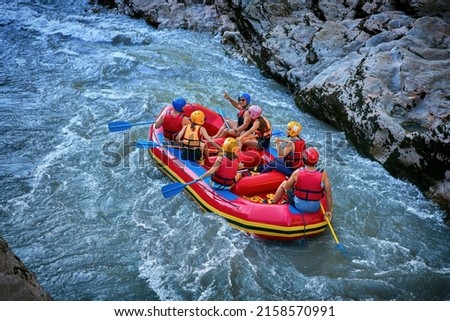 large team is rafting on the river