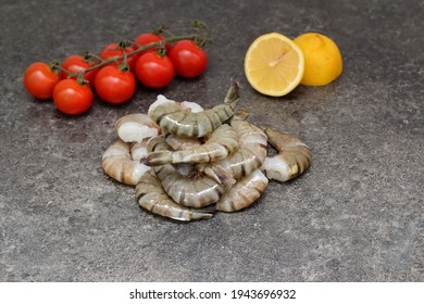 Large Tiger Prawns On The Table With Tomatoes And Lemon