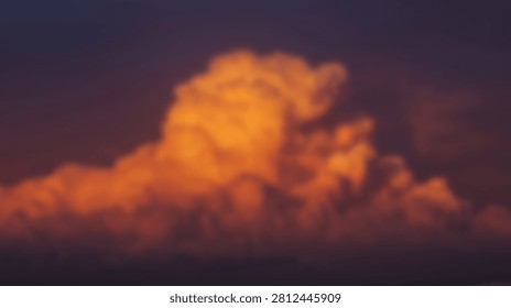 A large, towering cumulonimbus cloud is dramatically lit by the warm, golden hues of a setting sun, creating a striking contrast against the darkening sky.