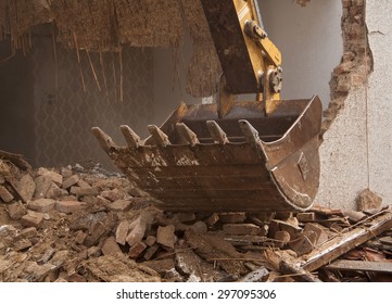 A Large Track Hoe Excavator Tearing Down An Old House