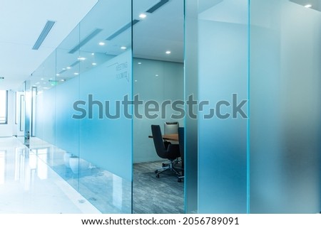 Large translucent glass blocks the meeting room, neat chairs, notice boards, poster materials