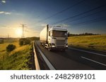 Large Transportation Truck on a highway road through the countryside at sunset