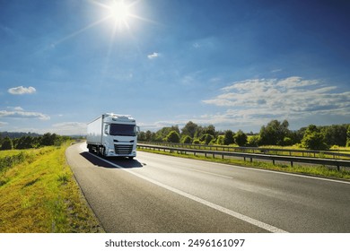 Large Transportation Truck on a highway road through the countryside at sunset