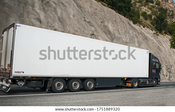 Large truck\
carrying goods on a mountain road. Freight transport. Volvo truck.\
Romania, Orsova. June, 06,\
2020