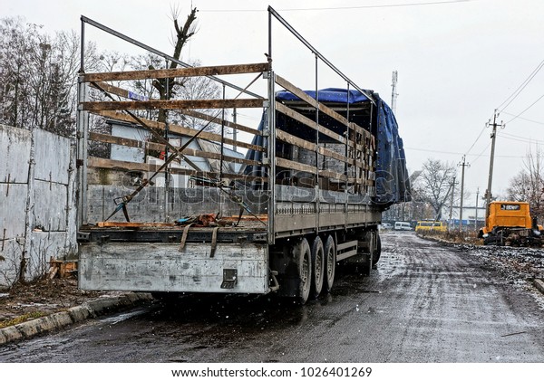 A\
large truck with an empty trailer stands on the\
street