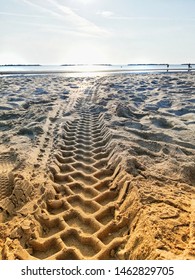 Large Truck Tire Tracks In Sand On The Seashore,Large Truck Tire Tracks In Sand,traces Of Tractor Tires In A Large Mud, Rural Muddy Road After Rain, Etched Traces In The Mud