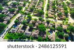 Large two-story suburban houses with swimming pool in upscale residential neighborhood North of Dallas, Texas, lush greenery area of Coppell, DFW Fort Worth metroplex urban sprawl, aerial view. USA