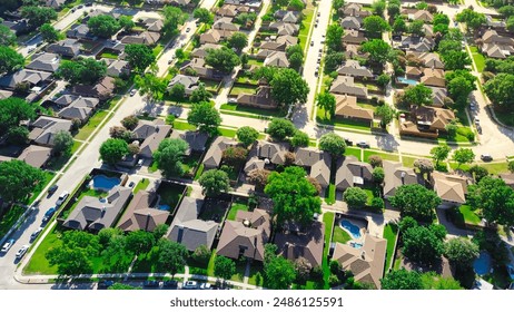 Large two-story suburban houses with swimming pool in upscale residential neighborhood North of Dallas, Texas, lush greenery area of Coppell, DFW Fort Worth metroplex urban sprawl, aerial view. USA - Powered by Shutterstock