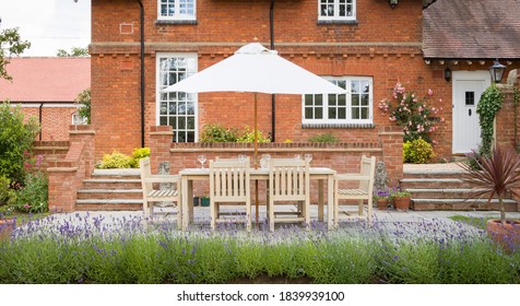 Large UK Country House With Garden Furniture On A Patio In A Back Garden