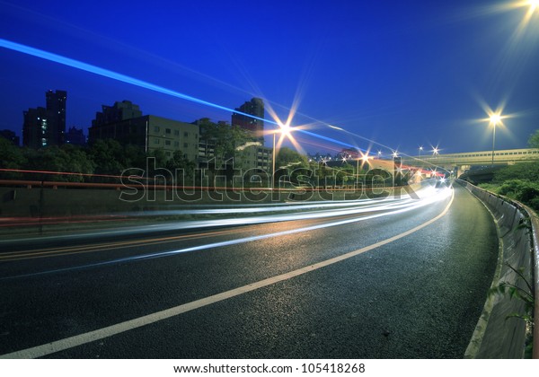 Large urban ring highway viaduct long exposure\
photo light trails night\
scene