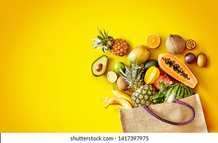 Large Variety Of Healthy Fresh Tropical Fruit On Exotic Yellow Background With Copy Space And Vignette In Panorama Banner Format