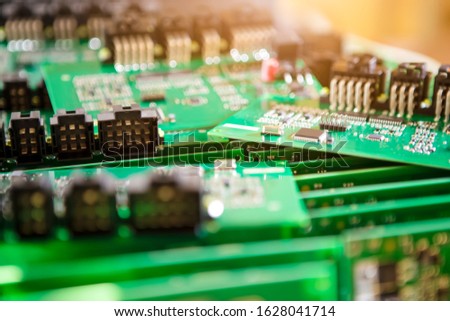 Large Variety of Just Produced Automotive Printed Circuit Boards with Surface Mounted Components with PCBs On Top of Boards. Shallow DOF.  Horizontal Image