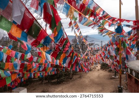 Large volume of Prayer Flags and Prayer Wheels at hilltop of Baiji Temple, Baijisi, Shangri-la, Yunnan, China