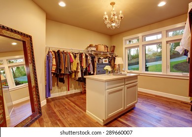 Large Walk In Closet With Hardwood Floor And An Island.