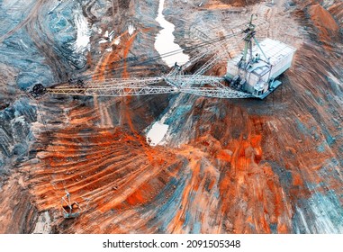 A large walking excavator works in a quarry for the extraction of rare metals. Drone view. Industrial landscape. - Shutterstock ID 2091505348