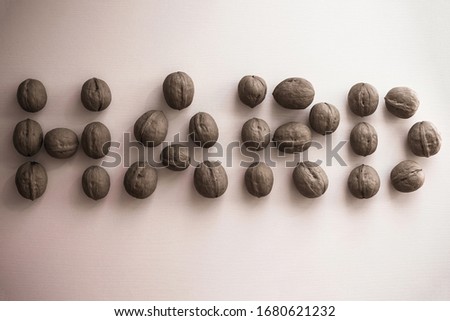 Large walnuts, strong shell. Hard inscription on a light background. Toughie, difficult situation, problem.