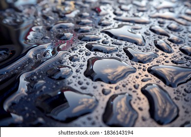 Large Water Drops Close Up On Dark Blue Metal Surface Side View