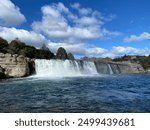 Large waterfall featuring small rainbow near Murchison, New Zealand