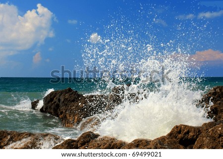 Large wave crash against the rocks during a storm in the tropics