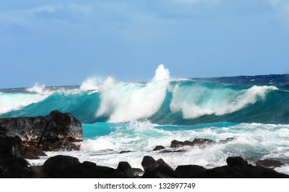 Large Wave Curls And Spills Over Itself As It Crashes Against The Rocks In Mackenzie State Park On The Big Island Of Hawaii.  Windy Conditions Causes Ocean To Produce Large Waves And Spray.