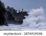 Large waves crashing against cliffs at Cape Disappointment on the Washington coast during King Tide