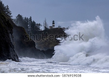 Large waves crashing against cliffs at Cape Disappointment on the Washington coast during King Tide