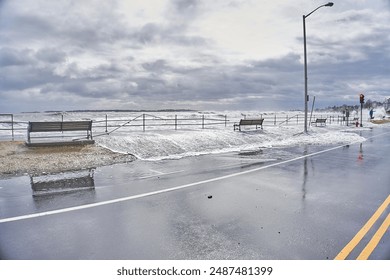 Large waves at high tide causing damage and flooding of the sidewalk and streets 