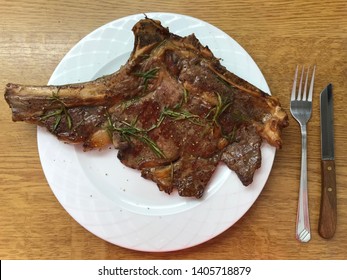 Large Well Done Beef Steak Exceeding The Serving Plate