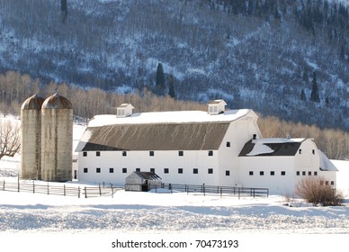 Large White Barn In The Mountains Near Park City, Utah During Winter.