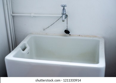 A Large White Belfast Sink In A Utility Room