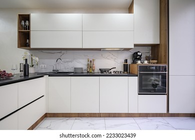Large white and black luxury kitchen interior, whole front view - Shutterstock ID 2233023439