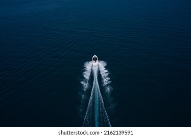 Large White Boat Fast Movement On Blue Water Aerial View. Drone View Of A Boat Sailing. Top View Of A White Boat Sailing To The Blue Sea. Motor Boat In The Sea. Travel - Image.