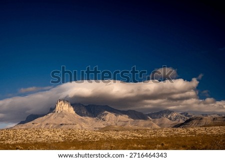 Large White Cloud Separates Guadalupe Mountains and The Deep Blue Sky Above in West Texas