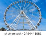 Large White Ferris Wheel with a blue sky