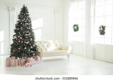 Large White Living Room With A Vintage Sofa And A Large Christmas Tree With Gifts And Large Panoramic Windows