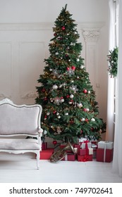 Large White Living Room With A Vintage Sofa And A Large Christmas Tree With Gifts And Large Panoramic Windows