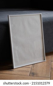 Large White Photo Frame On The Floor, Mockup, Poster Against The Wall, Dark Background