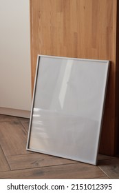 Large White Photo Frame On The Floor, Mockup, Poster Against The Wall, Dark Background